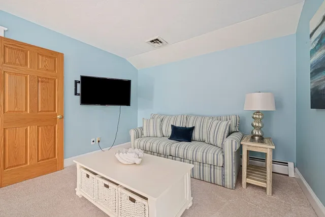 a bedroom with a large bed dresser and a window