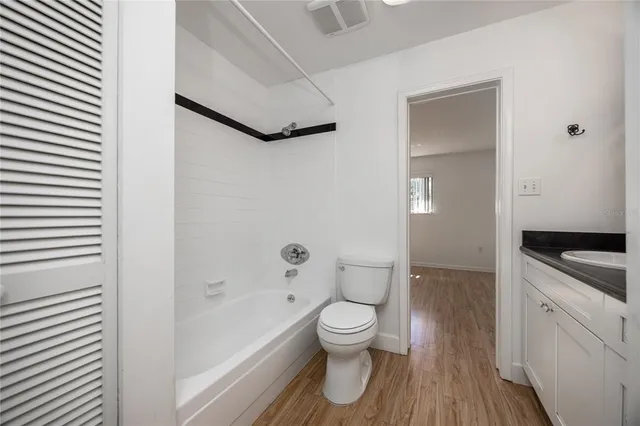 a white toilet sitting next to a bathroom sink