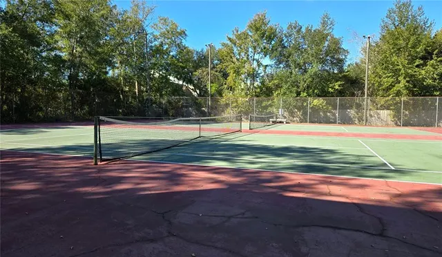 a front view of a house with a yard and potted plants