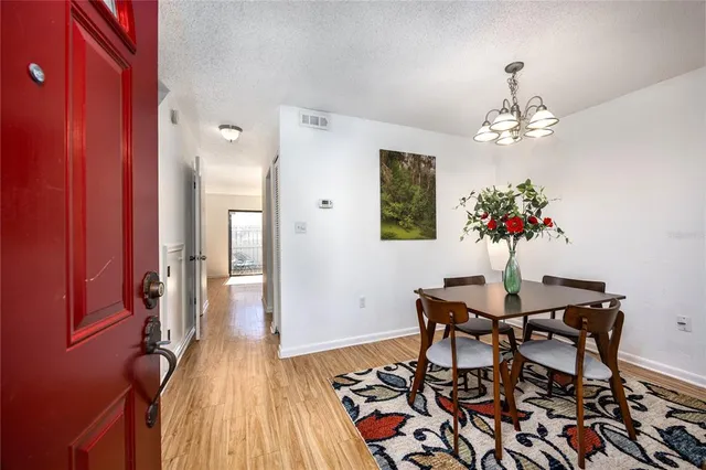 a view of a dining room with furniture and chandelier