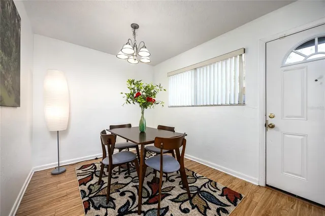 a view of a dining room with furniture and wooden floor