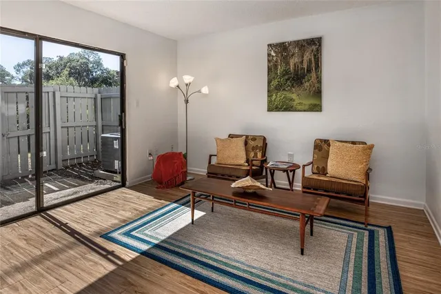 a living room with furniture and a floor to ceiling window