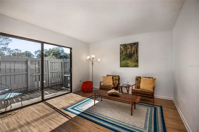a living room with furniture and a floor to ceiling window