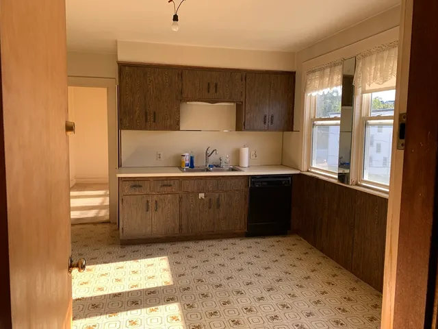 a kitchen with a sink and cabinets