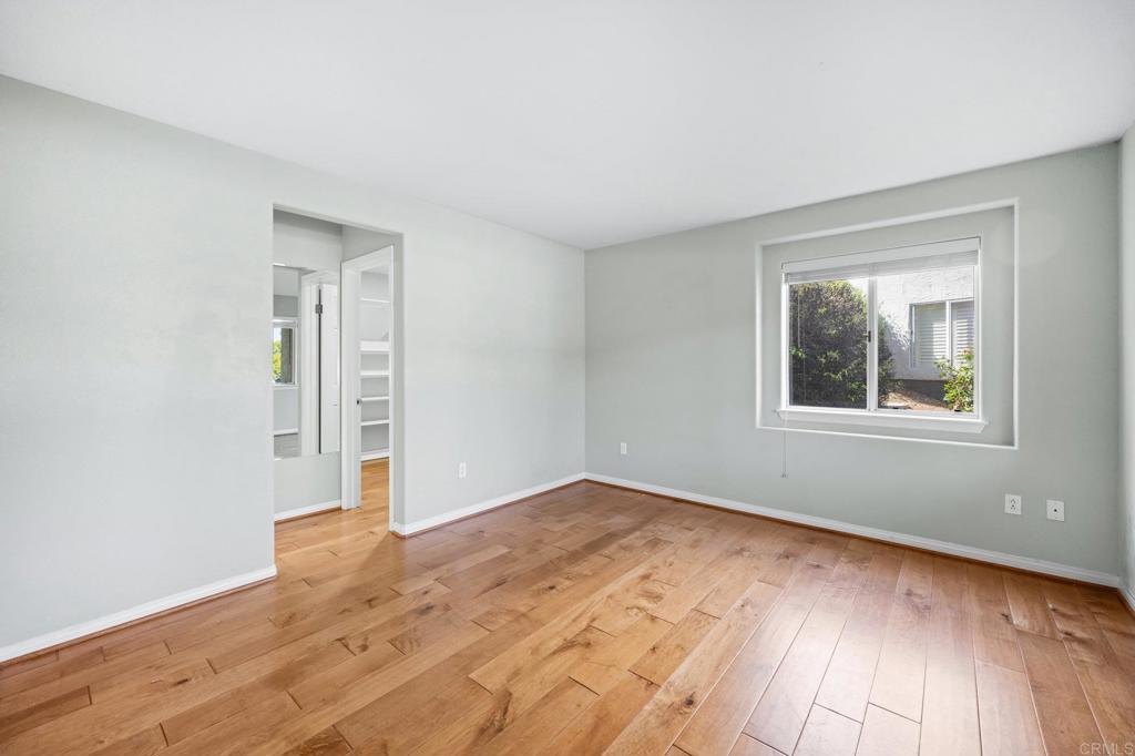 4009 Pala Mesa Oaks Drive Fallbrook, CA 92028 - Photo 14 of 45 an empty room with wooden floor and windows