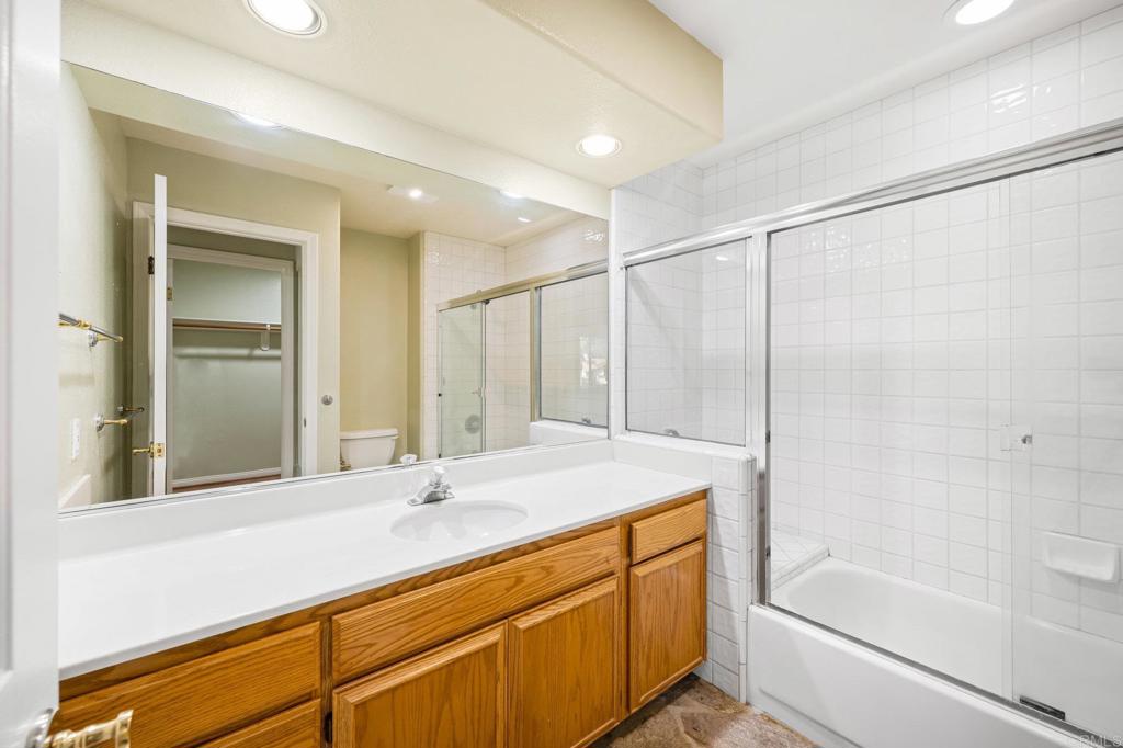 4009 Pala Mesa Oaks Drive Fallbrook, CA 92028 - Photo 15 of 45 a bathroom with a bathtub shower sink vanity and mirror