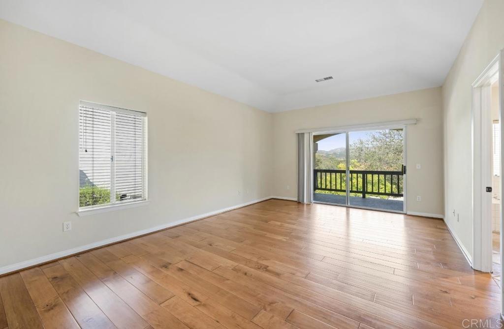 4009 Pala Mesa Oaks Drive Fallbrook, CA 92028 - Photo 26 of 45 a view of an empty room with wooden floor and a window