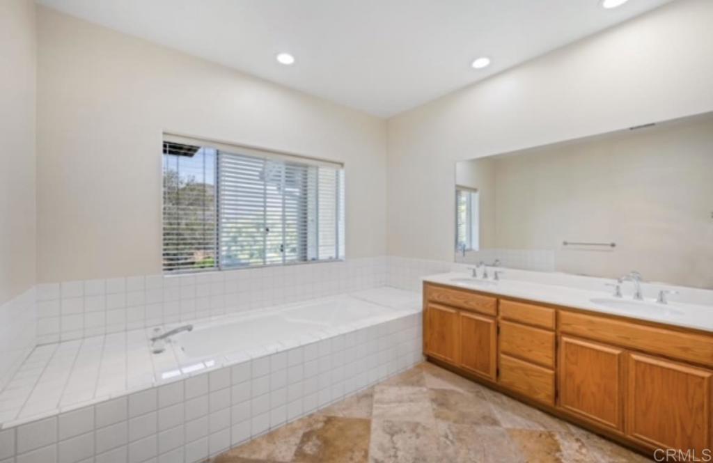 4009 Pala Mesa Oaks Drive Fallbrook, CA 92028 - Photo 28 of 45 a spacious bathroom with a tub sink and mirror