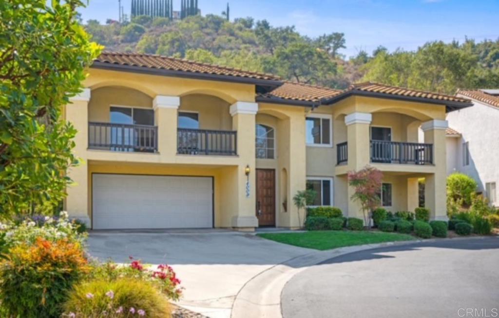 4009 Pala Mesa Oaks Drive Fallbrook, CA 92028 - Photo 3 of 45 a front view of a house with a yard and garage