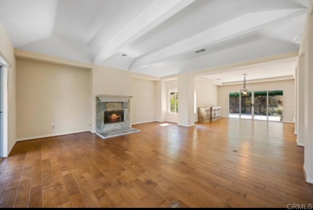 4009 Pala Mesa Oaks Drive Fallbrook, CA 92028 - Photo 7 of 45 a view of empty room with fireplace and wooden floor