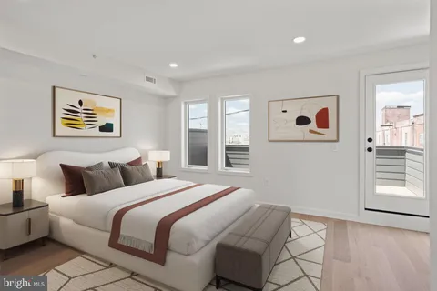 a bedroom with bed and painting on the wall