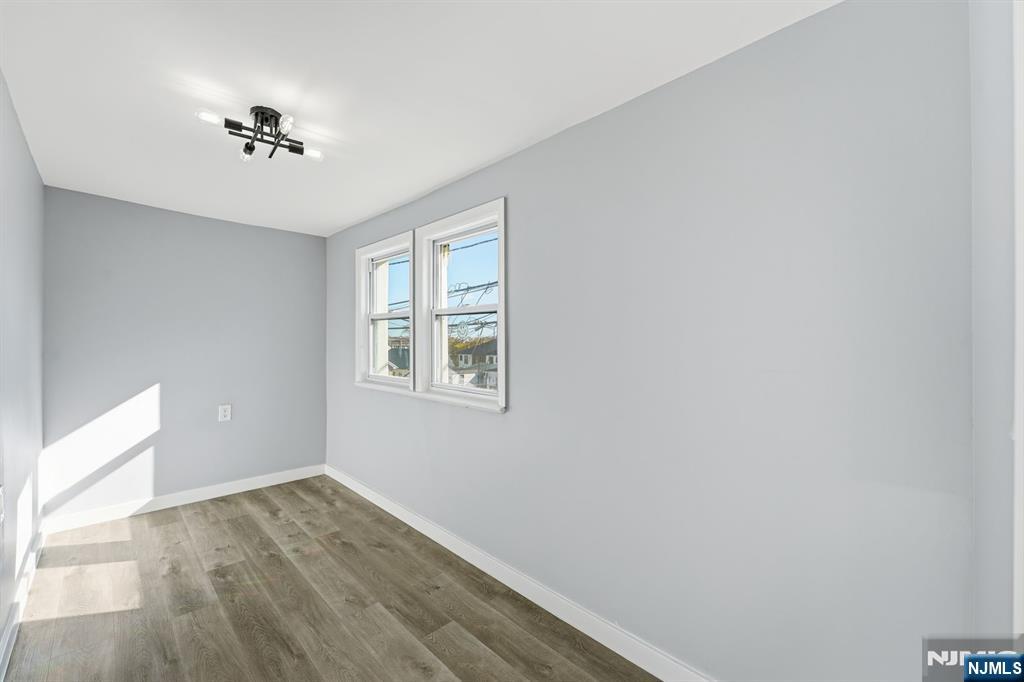 20 Wickham Street Passaic, NJ 07055 - Photo 12 of 20 wooden floor in an empty room with a window