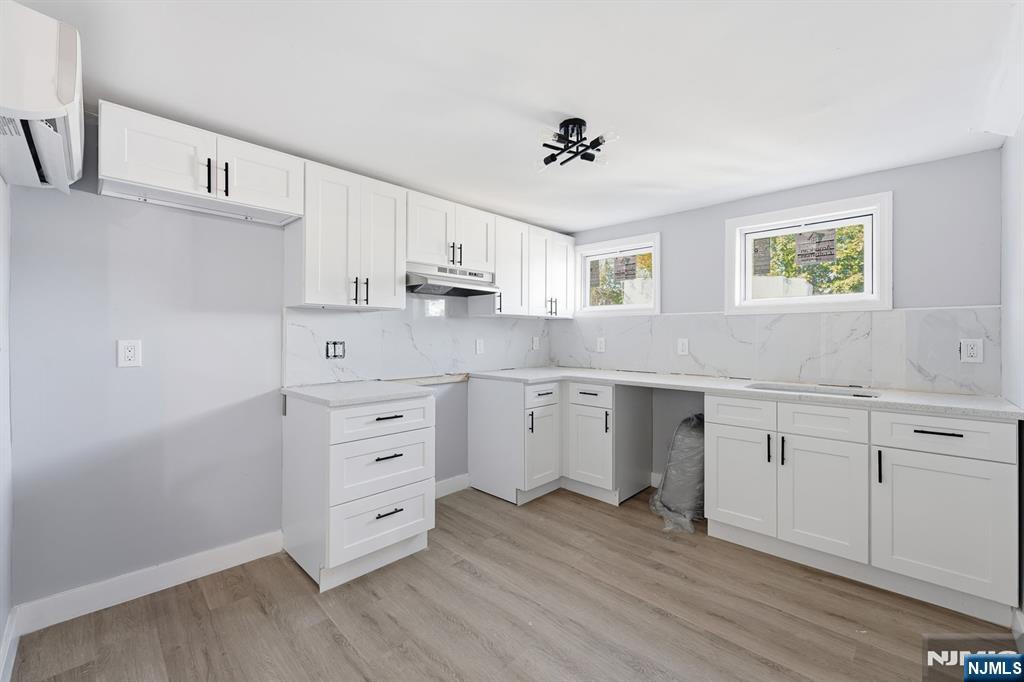 20 Wickham Street Passaic, NJ 07055 - Photo 14 of 20 a kitchen with cabinets wooden floor and stainless steel appliances