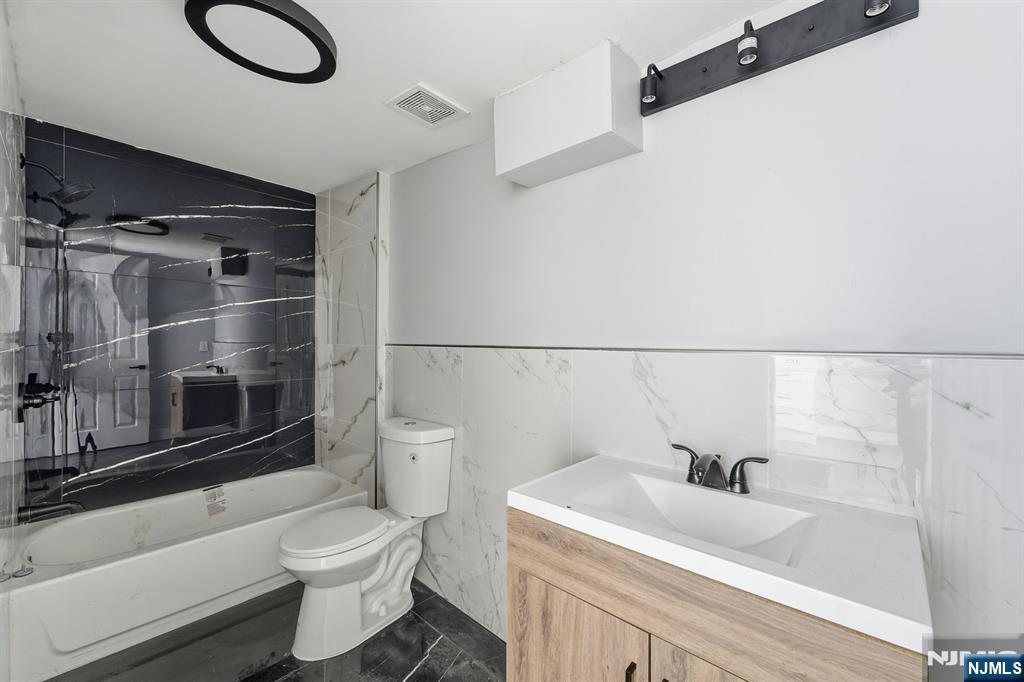 20 Wickham Street Passaic, NJ 07055 - Photo 15 of 20 a bathroom with a sink toilet and shower