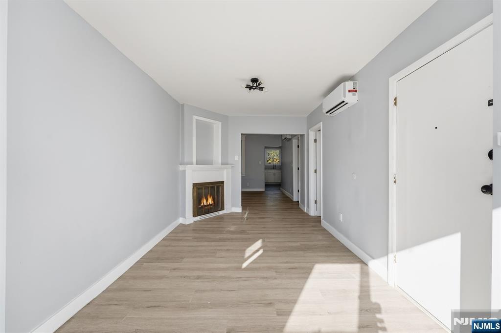 20 Wickham Street Passaic, NJ 07055 - Photo 3 of 20 a view of a livingroom with wooden floor and a ceiling fan