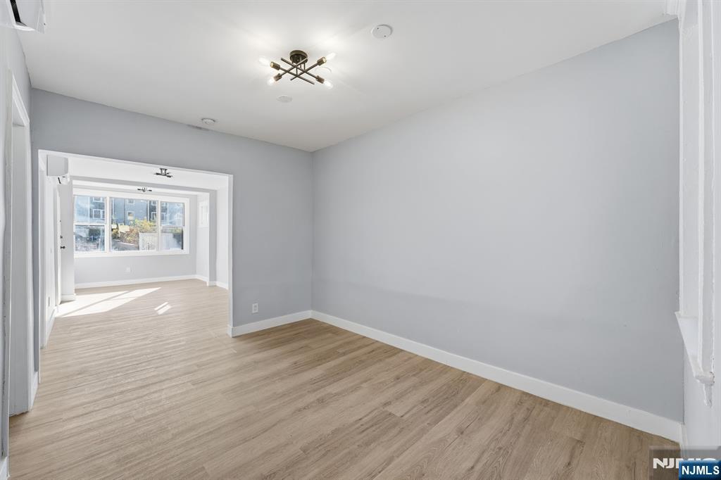 20 Wickham Street Passaic, NJ 07055 - Photo 4 of 20 wooden floor in an empty room with a window