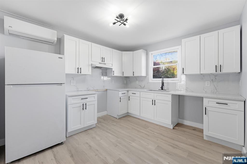 20 Wickham Street Passaic, NJ 07055 - Photo 5 of 20 a kitchen with cabinets appliances wooden floor and a window