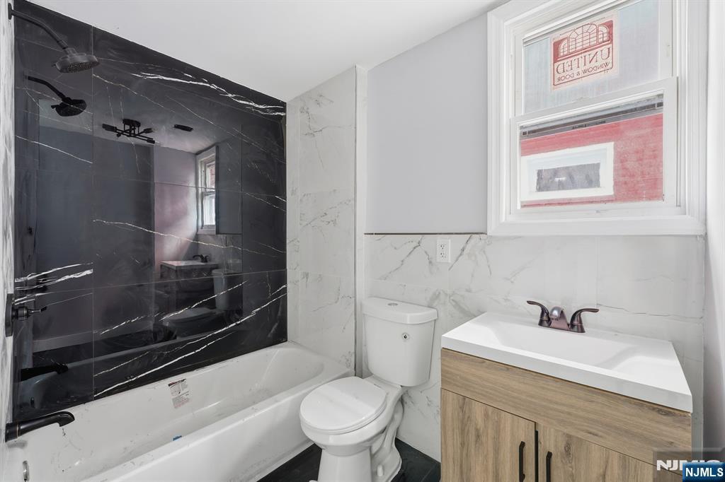 20 Wickham Street Passaic, NJ 07055 - Photo 6 of 20 a bathroom with a sink a toilet and shower