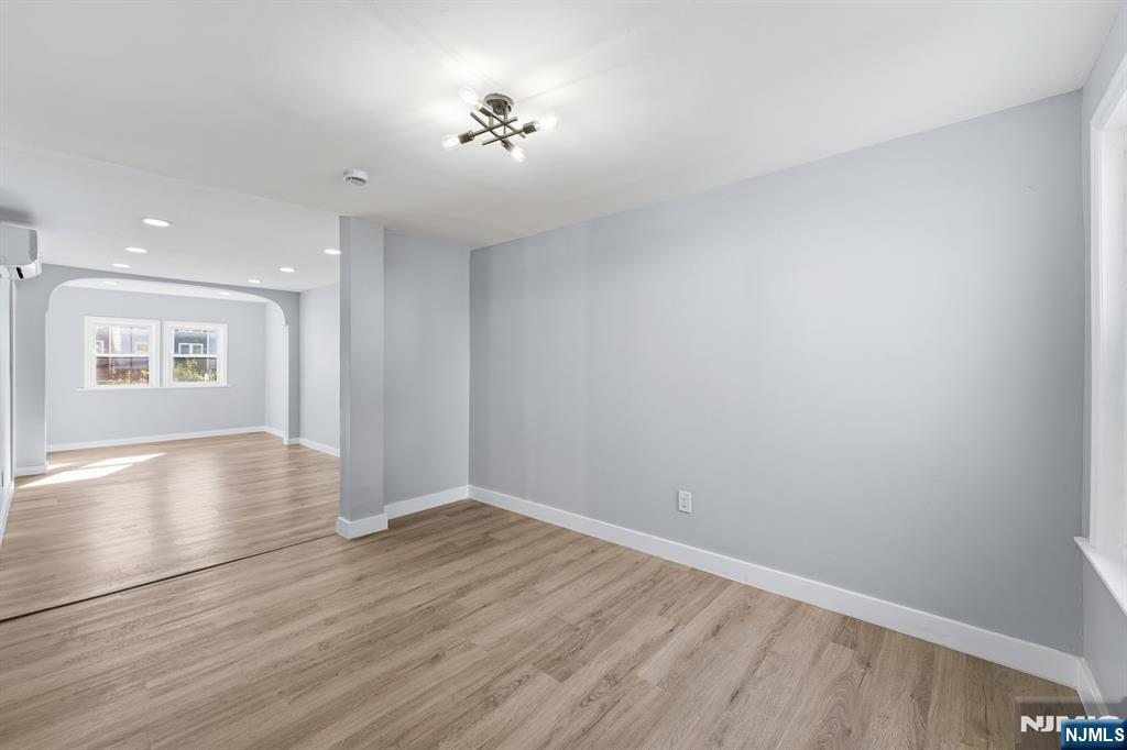 20 Wickham Street Passaic, NJ 07055 - Photo 10 of 20 a view of empty room with wooden floor and fan