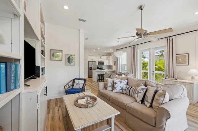 a kitchen with stainless steel appliances a table chairs and refrigerator