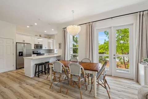 a kitchen with granite countertop white cabinets and stainless steel appliances