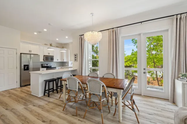 a kitchen with granite countertop white cabinets and stainless steel appliances