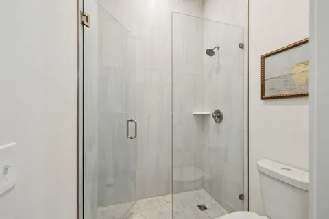 a bathroom with a double vanity sink mirror and shower