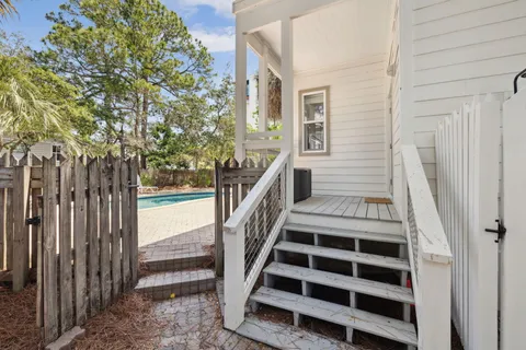 a view of a livingroom with wooden floor a flat screen tv and a dresser