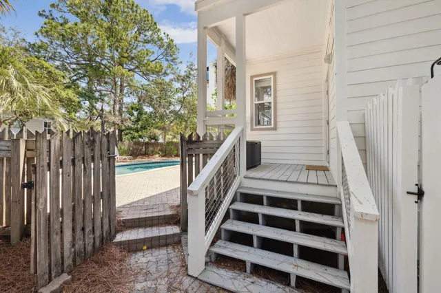 a view of a livingroom with wooden floor a flat screen tv and a dresser