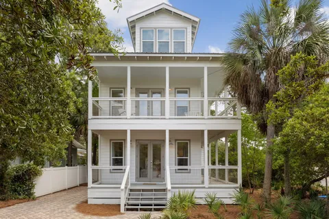 a living room with furniture a flat screen tv and a floor to ceiling window