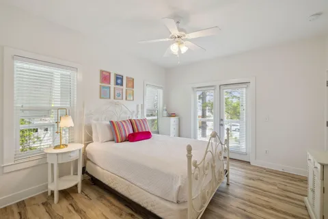 a bedroom with furniture and large window