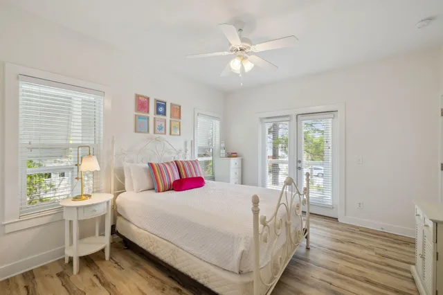 a bedroom with furniture and large window