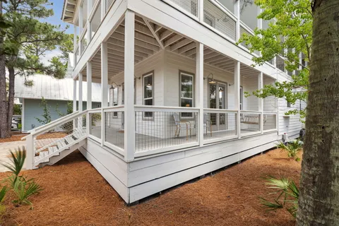 a living room with furniture a rug and a flat screen tv