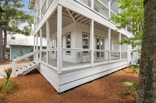a living room with furniture a rug and a flat screen tv