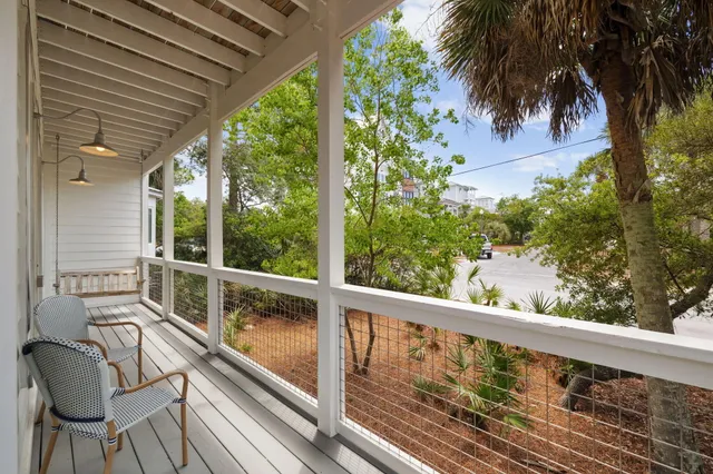 a living room with furniture flat screen tv and window