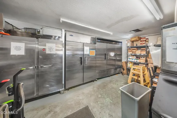 a hallway with a door and a painting on the wall