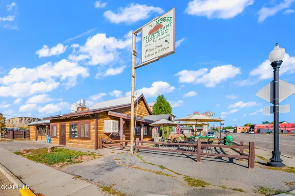 a patio with a table and chairs under an umbrella