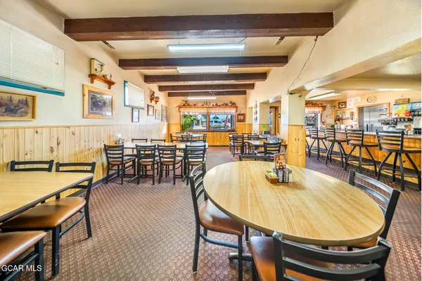 a living room with lots of furniture and kitchen view