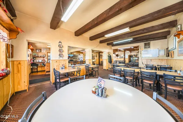 a living room with lots of furniture and a wooden floor
