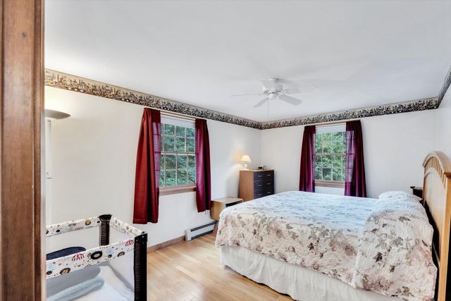 a bed sitting in a bedroom next to a window