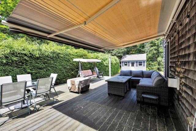 a view of house with backyard and sitting area