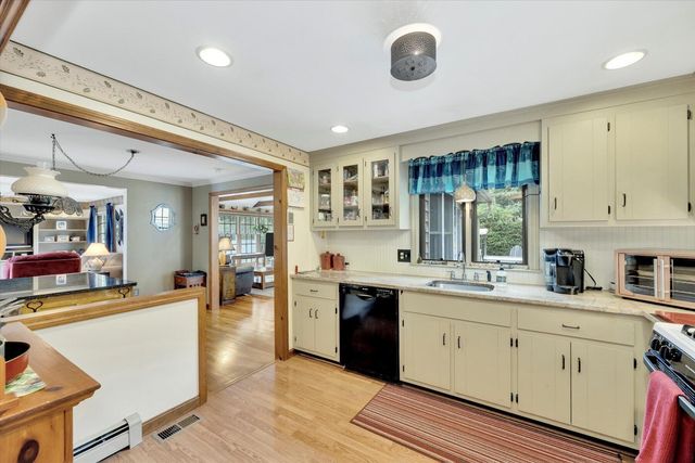a kitchen with stainless steel appliances granite countertop a sink and cabinets