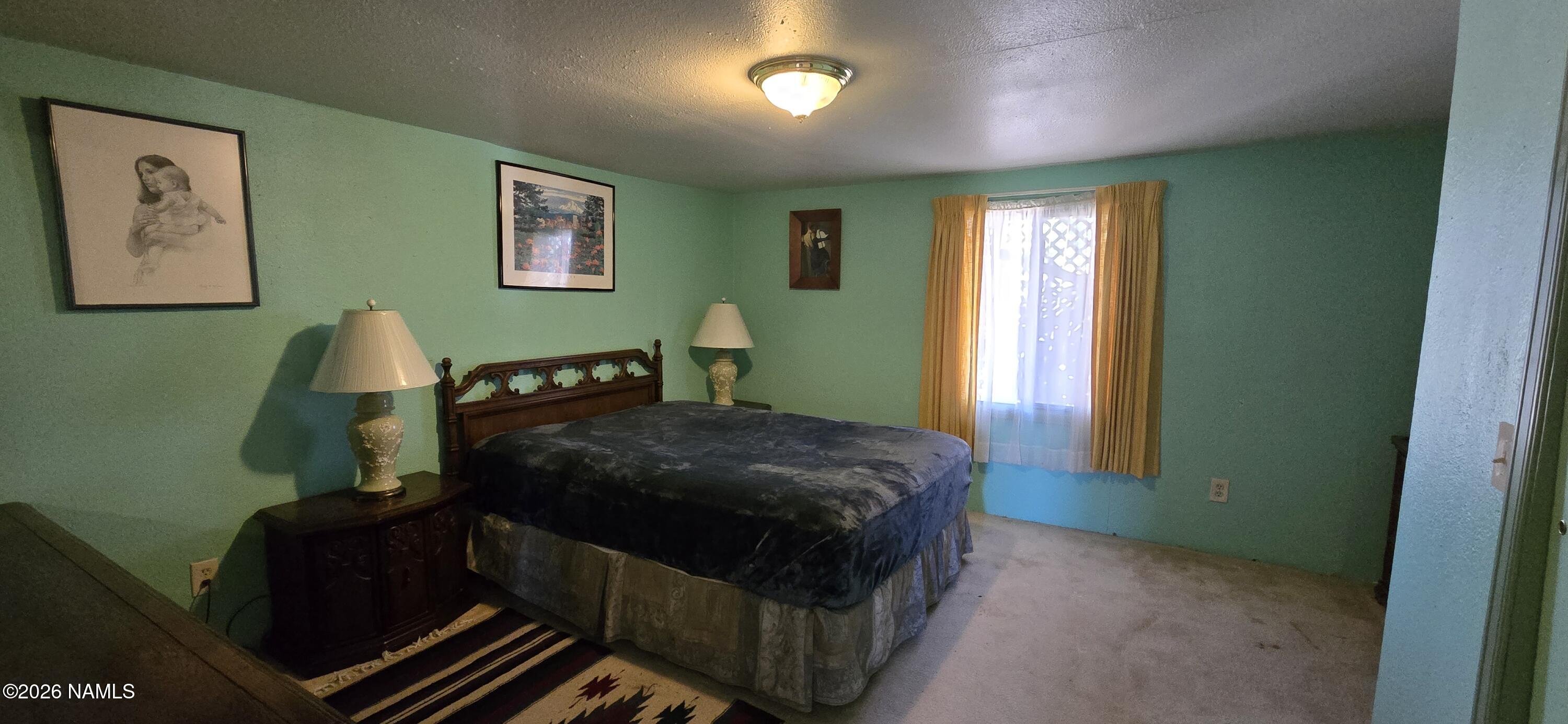 2795 Poppy Road Ash Fork, AZ 86320 - Photo 14 of 56 a bedroom with a bed and a window