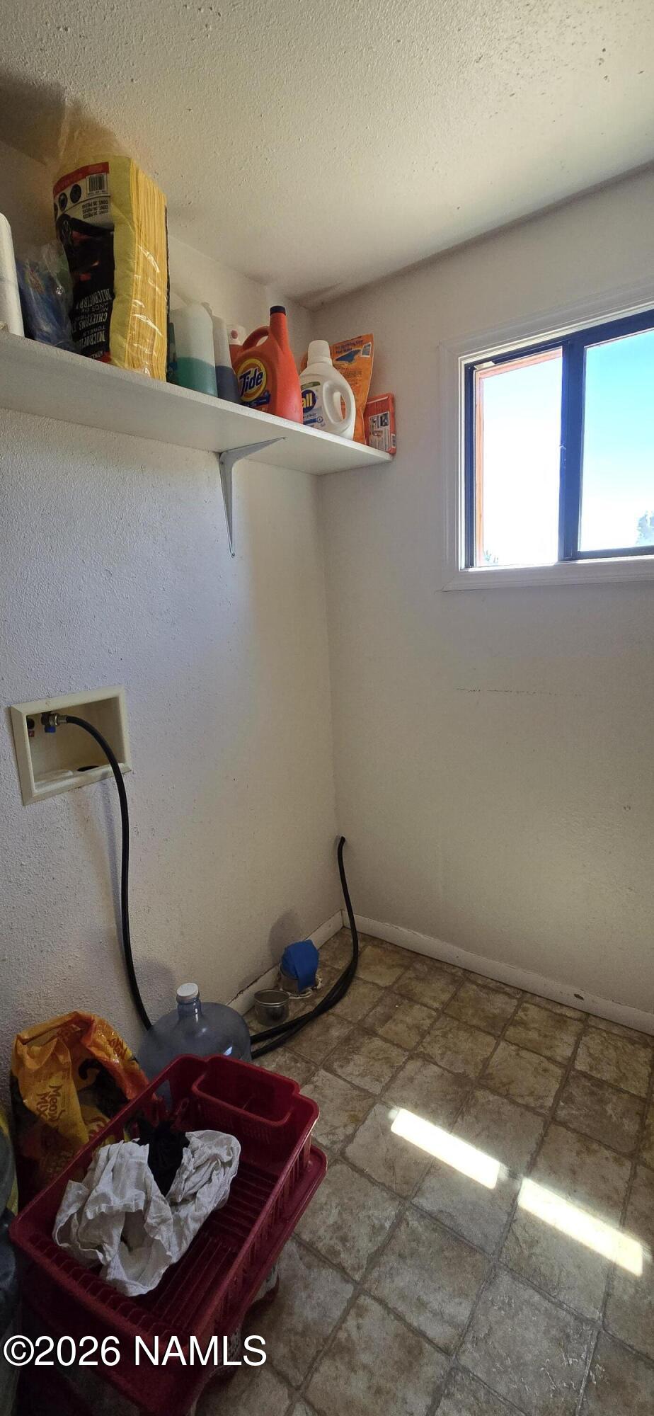 2795 Poppy Road Ash Fork, AZ 86320 - Photo 20 of 56 a room with water heater and racks on the wall