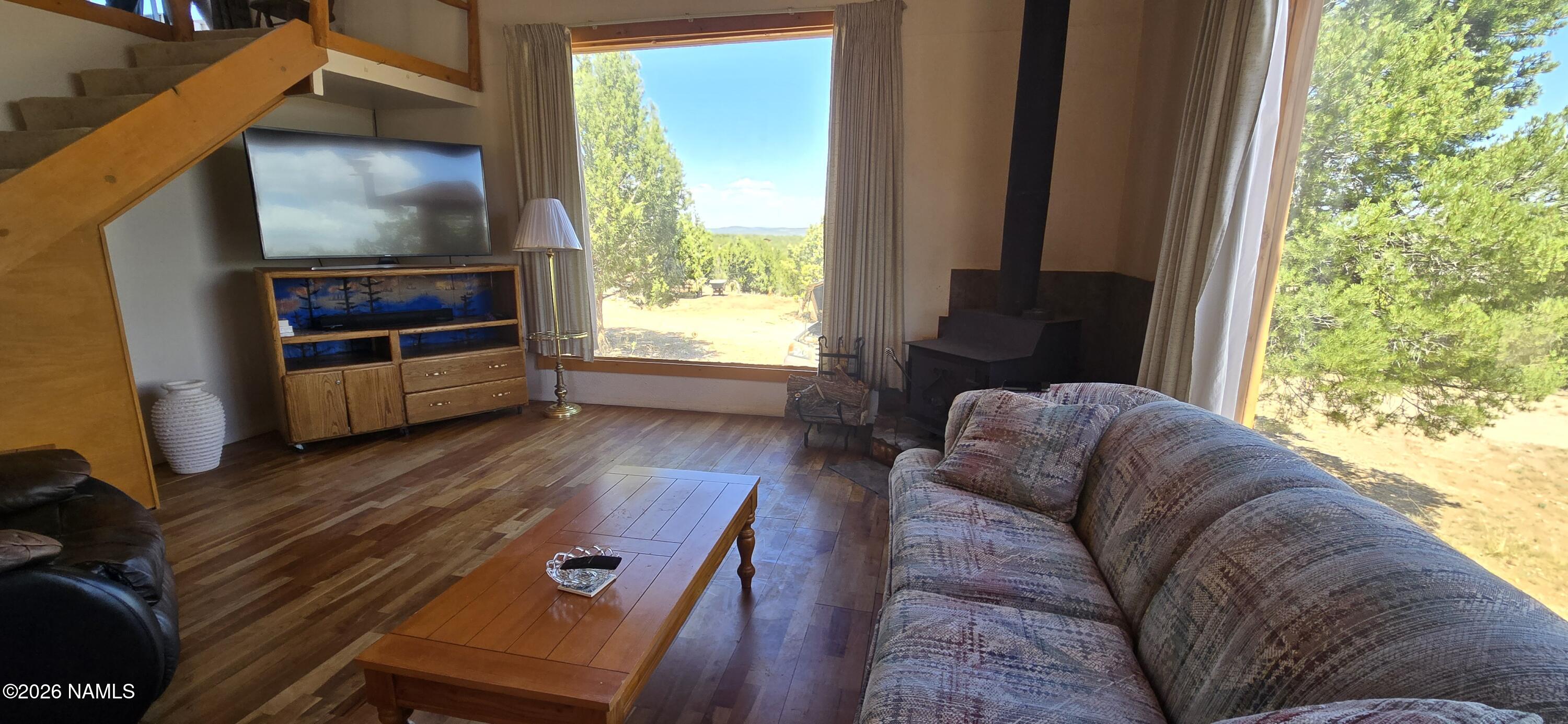 2795 Poppy Road Ash Fork, AZ 86320 - Photo 21 of 56 a living room with furniture and a flat screen tv