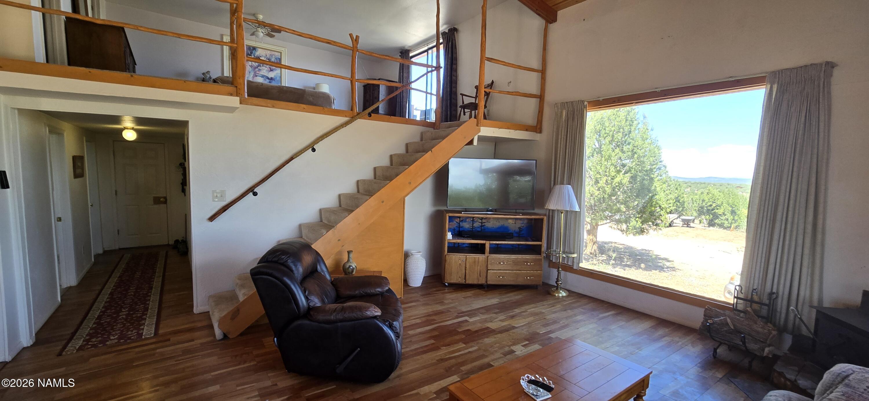 2795 Poppy Road Ash Fork, AZ 86320 - Photo 22 of 56 a living room with furniture and a wooden floor