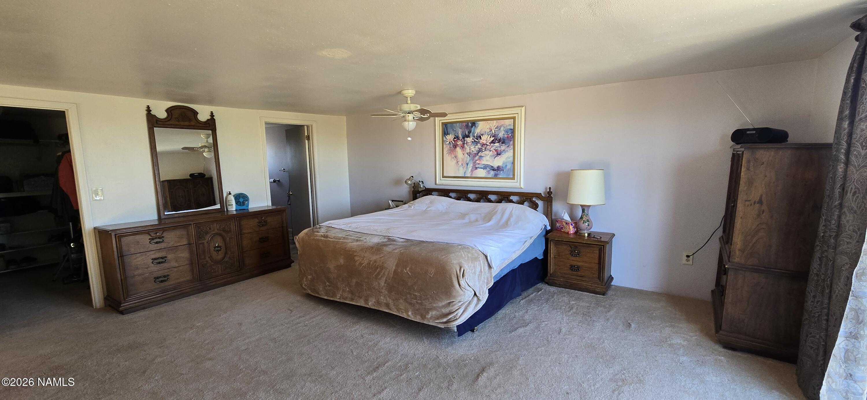 2795 Poppy Road Ash Fork, AZ 86320 - Photo 25 of 56 a spacious bedroom with a bed and a dresser