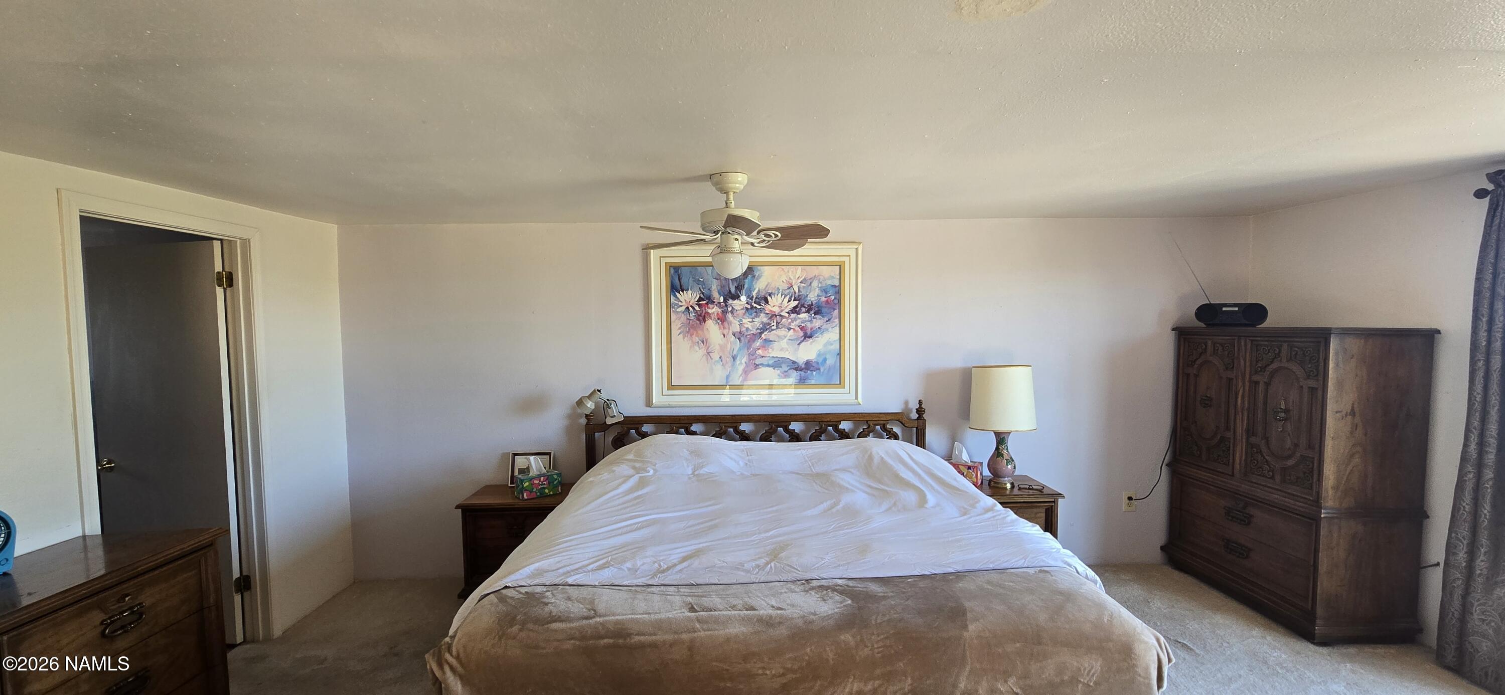 2795 Poppy Road Ash Fork, AZ 86320 - Photo 26 of 56 a bed sitting in a bedroom next to a window