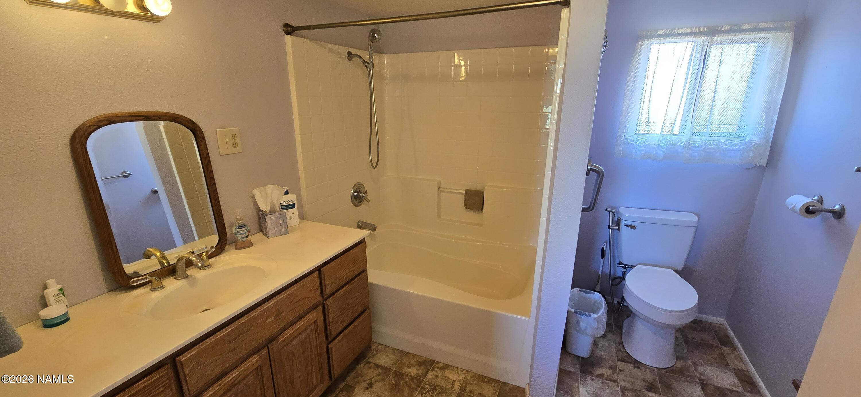 2795 Poppy Road Ash Fork, AZ 86320 - Photo 28 of 56 a bathroom with a sink a toilet and shower