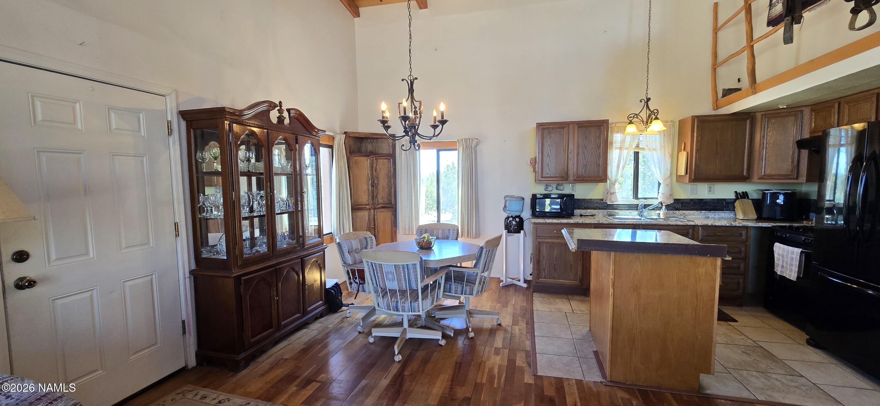 2795 Poppy Road Ash Fork, AZ 86320 - Photo 4 of 56 a view of a dining room with furniture window and wooden floor
